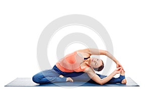 Sporty fit yogini woman practices yoga asana parivrtta janu sirs