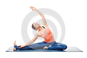 Sporty fit yogini woman practices yoga asana parivrtta janu sirs