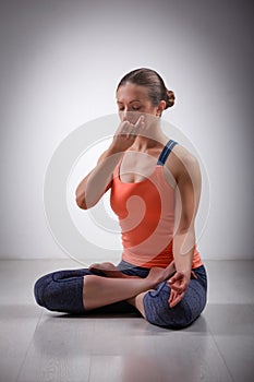Sporty fit yogini woman practices yoga pranayama