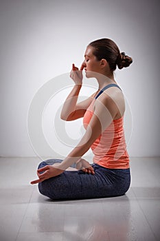 Sporty fit yogini woman practices yoga pranayama photo
