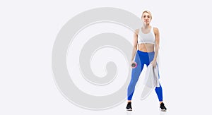 Sporty fitness blonde beautiful woman in sportswear posing in studio