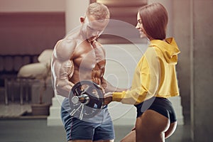 Sporty fitness couple working out in gym