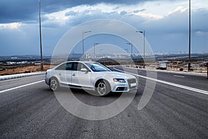 Sporty German Audi sedan on a winding mountain road..