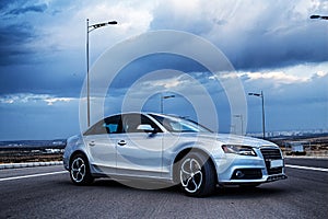 Sporty German Audi sedan on a winding mountain road. Corner view