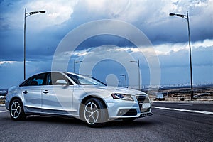 Sporty German Audi sedan on a winding mountain road. Corner view.