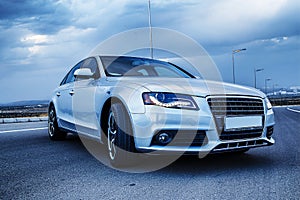 Sporty German Audi sedan on a winding mountain road. At evening