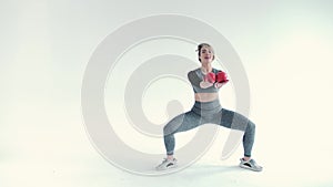 Sporty girl with ball for gymnastics. Photo of strong young girl in training muscles hands on grey background. Strength