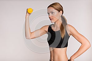 Sporty girl doing exercise with dumbbells