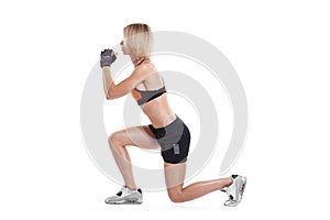 Sporty girl doing lunge isolated
