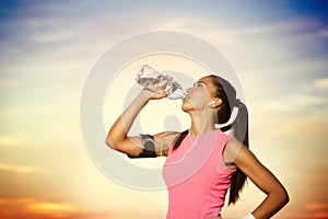 Sporty girl drinking water