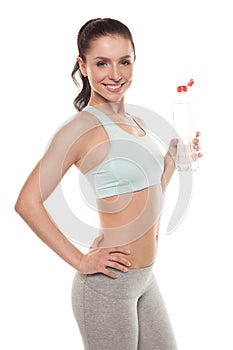 Sporty girl drinking water from a bottle after a workout, fitness training, isolated on white background