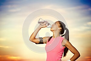 Sporty girl drinking water photo