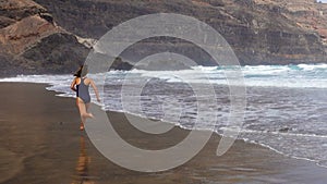 Sporty girl on Playa de Orzola beach in Lanzarote, Canary Islands