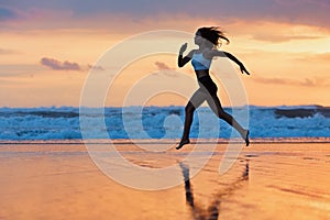 Sporty girl running by beach along sea surf