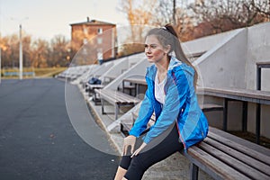 Sporty girl on the stadium. Stadium tribune. Slim sporty fitness woman.