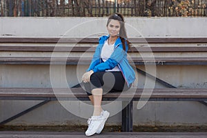 Sporty girl on the stadium. Stadium tribune. Slim sporty fitness woman.