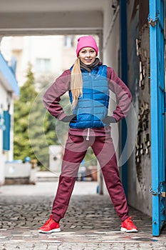 Sporty girl stretching outdoor on city street.