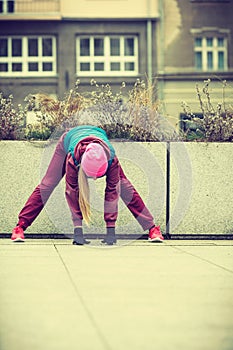 Sporty girl stretching outdoor on city street