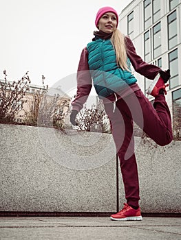 Sporty girl stretching outdoor on city street