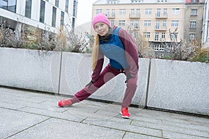 Sporty girl stretching outdoor on city street