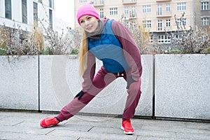 Sporty girl stretching outdoor on city street