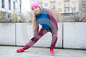 Sporty girl stretching outdoor on city street