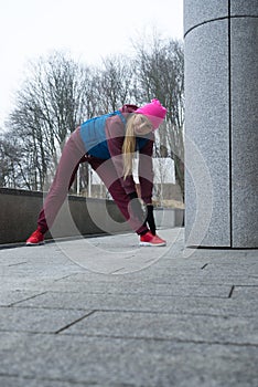 Sporty girl stretching outdoor on city street