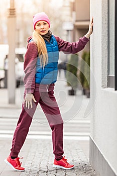 Sporty girl stretching outdoor on city street