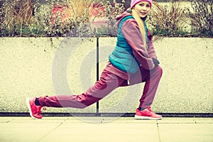 Sporty girl stretching outdoor on city street