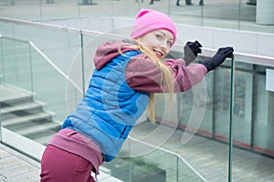 Sporty girl stretching outdoor on city street