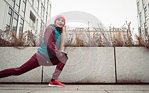 Sporty girl stretching outdoor on city street