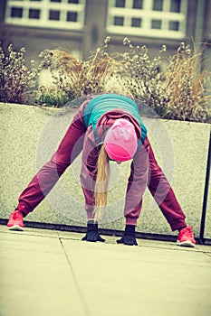 Sporty girl stretching outdoor on city street