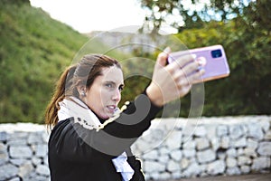 Sporty girl taking a self portrait photography at park.