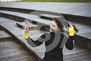 Sporty girl taking a self portrait photography at park.