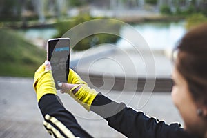 Sporty girl taking a self portrait photography at park.