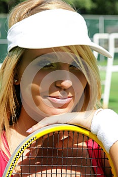 Sporty girl in tennis cap smiling