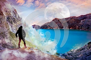 Sporty guy against the background of the alien landscape. Mountains, the lake and sky with moon.