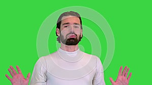 Sporty guy talking on camera on a Green Screen, Chroma Key.