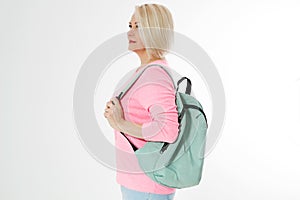 Sporty happy middle age beautiful woman with backpack isolated on white background. Copy space. Mid aged women healthy lifestyle.