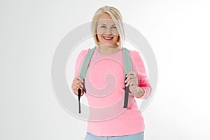 Sporty happy middle age beautiful woman with backpack isolated on white background. Copy space. Mid aged women healthy lifestyle.