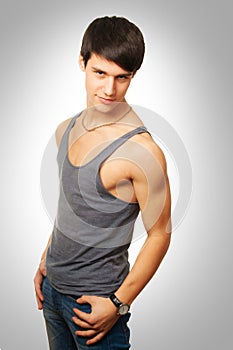 Sporty and healthy muscular man on gray background