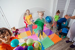 Sporty kids enjoying activities with young teacher