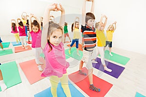 Sporty kids stretching during gymnastic activity