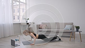 Sporty Lady Doing Push-Ups At Laptop During Workout At Home