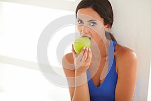 Sporty lady eating fruit for healthcare