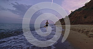Sporty lady enjoying the moment in the middle of beach side doing yoga poses meditation concentrated relaxing her mind