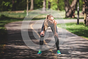 Attractive woman is warming-up in open air