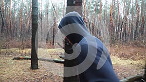 Sporty male runner jogging along trail at autumn forest. Young sportsman running along path at woodland. Strong athlete