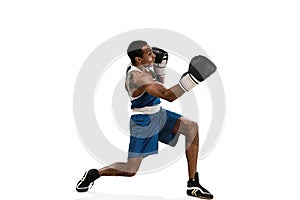 Sporty man during boxing exercise making hit. Photo of boxer on white background