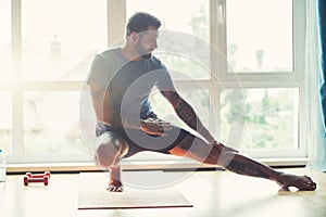 Sporty man doing exercise at home